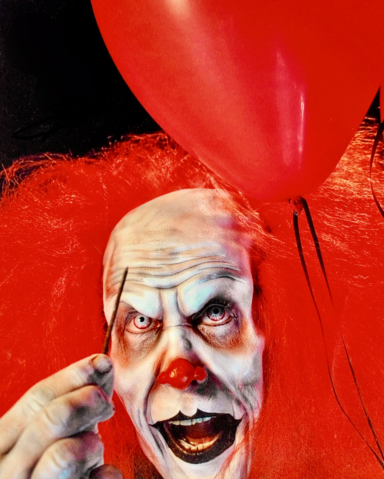Close up of The Clown foam latex prosthetic appliance. Red nose. Popping a balloon.